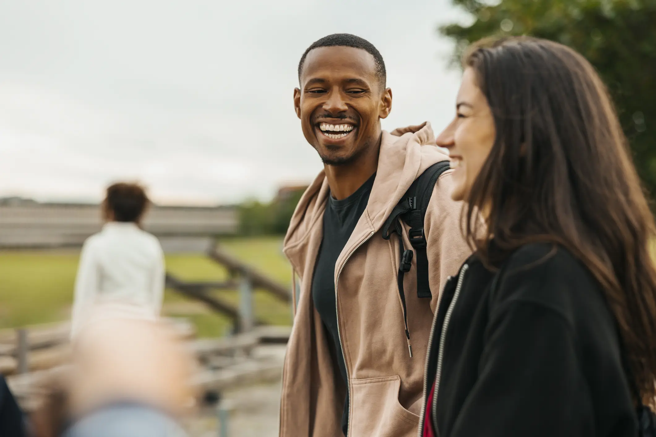 Man in a woman outside in a discussion.